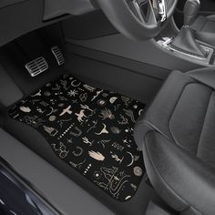 the interior of a car is decorated with black and white drawings, including an animal - themed floor mat