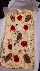 a piece of pizza with cherries and pecans on it sitting in a paper towel