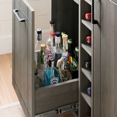 an open cabinet filled with bottles and liquor