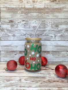 a mason jar with the word oh oh on it surrounded by christmas ornaments