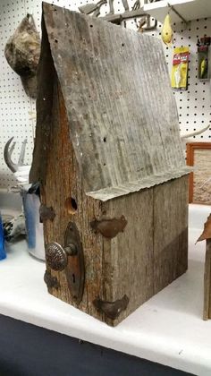 a birdhouse made out of wood on a table