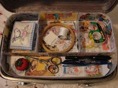 an open suitcase filled with various items on a bed