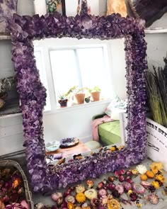 a mirror that has some flowers in it