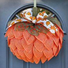 an orange mesh wreath hanging on the front door