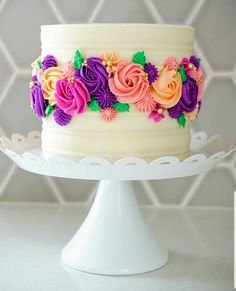 a white cake with colorful flowers on it