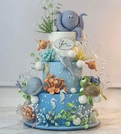 a three tiered cake decorated with sea animals