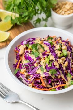 a white bowl filled with coleslaw, carrots and cilantro sauce