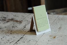 a small calendar sitting on top of a wooden table