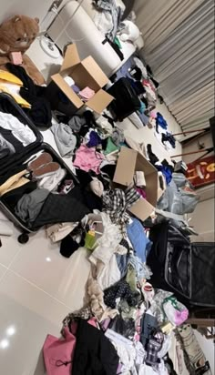 a pile of luggage sitting on top of a white tiled floor next to a wall