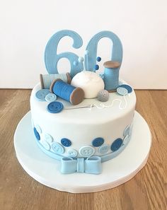 a birthday cake decorated with blue and white decorations