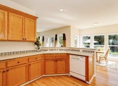 an empty kitchen with wooden cabinets and white appliances