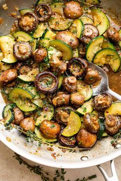 a skillet filled with cooked zucchini and mushrooms