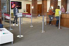 people are waiting in line at the check - in counter