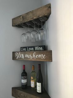 wine glasses and bottles are sitting on a shelf