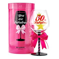 a pink wine glass with the words you are fabulous on it next to a gift box