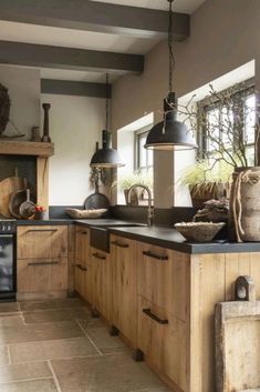 a kitchen filled with lots of wooden cabinets and counter top next to a stove top oven