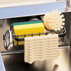 a sponge and rag are sitting in the dishwasher's drain, next to a towel rack