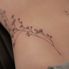 a woman's stomach with small flowers on it