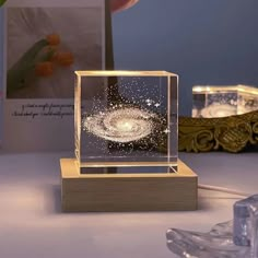 a wooden stand with a glass box on it and some lights in front of it