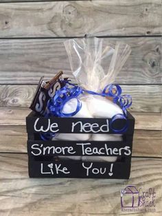 a small box with some kind of teacher's stuff in it on top of a wooden