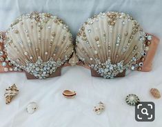 two seashells are adorned with pearls and jewels