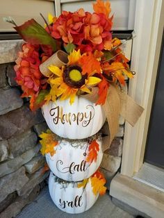 three pumpkins stacked on top of each other with the words happy fall written on them