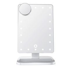 a white lighted mirror sitting on top of a table next to a stand with an electronic light