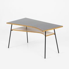 a wooden table with two black legs and a grey surface on the top, in front of a white background