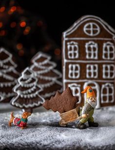 small figurines and gingerbread houses in the snow