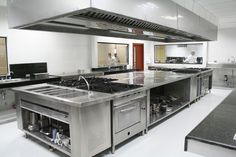 an industrial kitchen with stainless steel appliances and counter tops