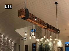 a room filled with lots of lights hanging from the ceiling and wooden beams above it