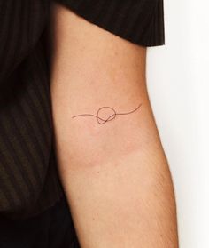 a woman's arm with a small tattoo on the left side of her body