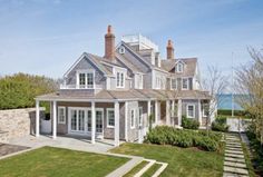 an image of a large house with lots of windows and grass in the front yard