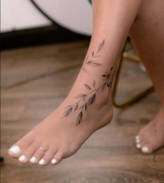 a woman's foot with a tattoo on it