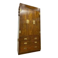 an old wooden armoire with brass hardware on it's doors and drawers, against a white background