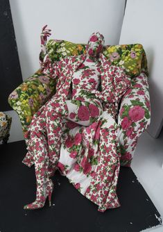 a chair covered in pink and green floral fabric