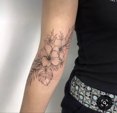 a woman with a flower tattoo on her arm