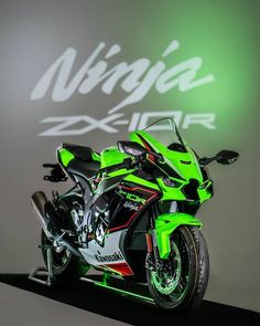 a green and black motorcycle is on display