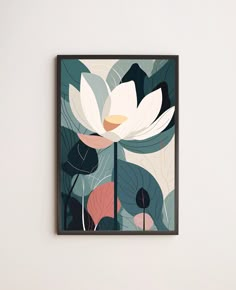 a white flower with green leaves in a black frame on the wall next to a lamp