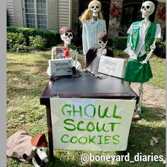 three skeletons dressed in costumes stand behind a sign that reads ghoul scout cookies