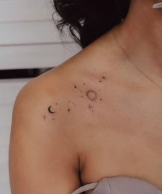 the back of a woman's shoulder with stars and planets on it