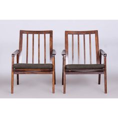 two wooden chairs sitting next to each other