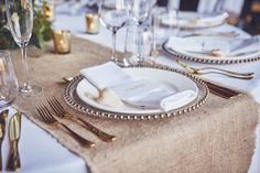 a table set with place settings and silverware for an elegant dinner or reception party