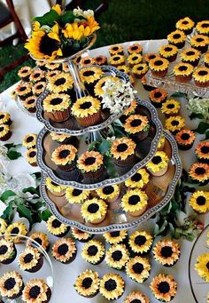 sunflower cupcakes are arranged on a table