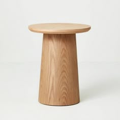 a small wooden table on a white background with no one around it or someone else