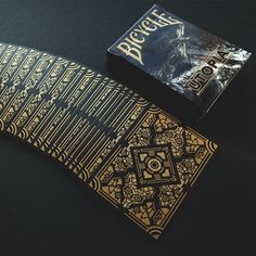 a playing card sitting on top of a table next to a box with the cover open