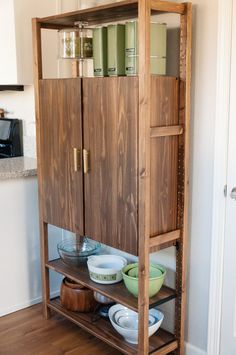 a wooden cabinet with plates and bowls on it