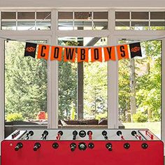 a foo - ball table in front of a window with the word tigers on it