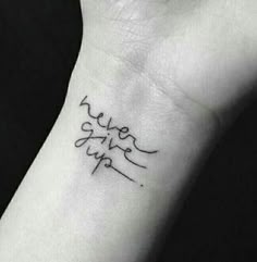 a wrist tattoo with the word love written on it