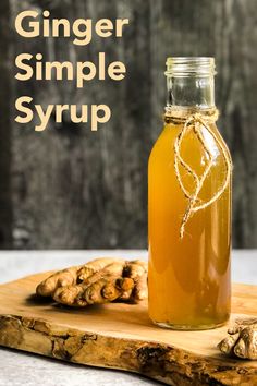 a bottle of ginger simple syrup on a cutting board